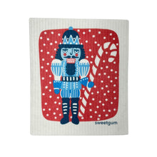 Load image into Gallery viewer, Blue Nutcracker Swedish Dishcloth | Red background with snow